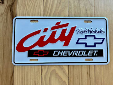 Rick Hendricks City Chevrolet Metal Booster License Plate
