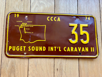 1974 Puget Sound Int'l Caravan Booster License Plate