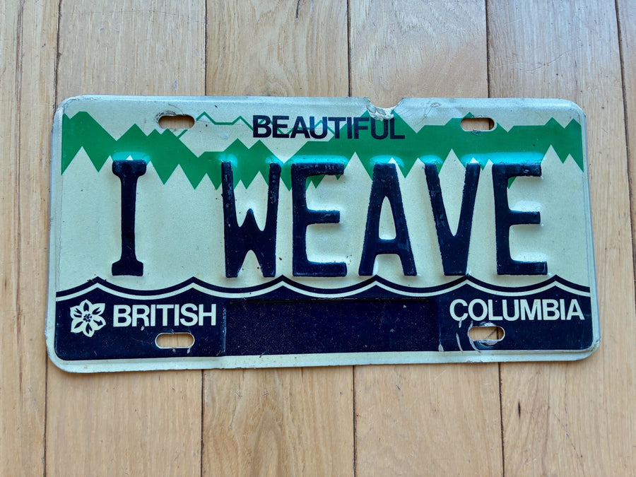 1984 British Columbia Vanity License Plate - I WEAVE (Damage On Top Above A)