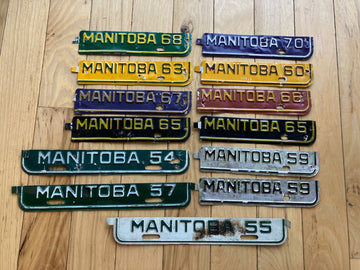 13 Manitoba License Plate Tabs From The 1950's to 1970's.