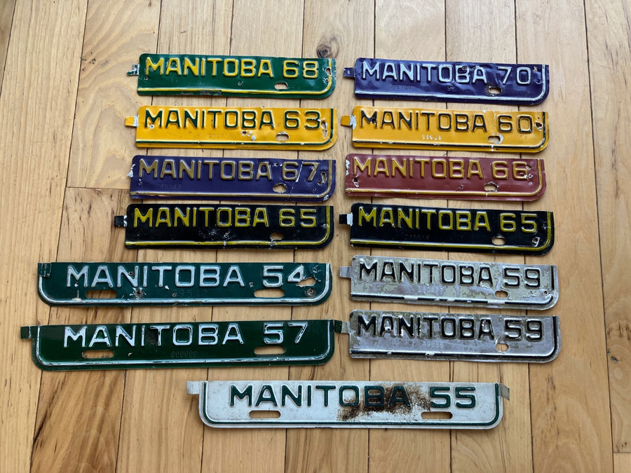 13 Manitoba License Plate Tabs From The 1950's to 1970's.